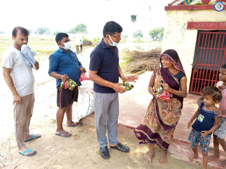 Team distributing cooked ration meal as a disaster response