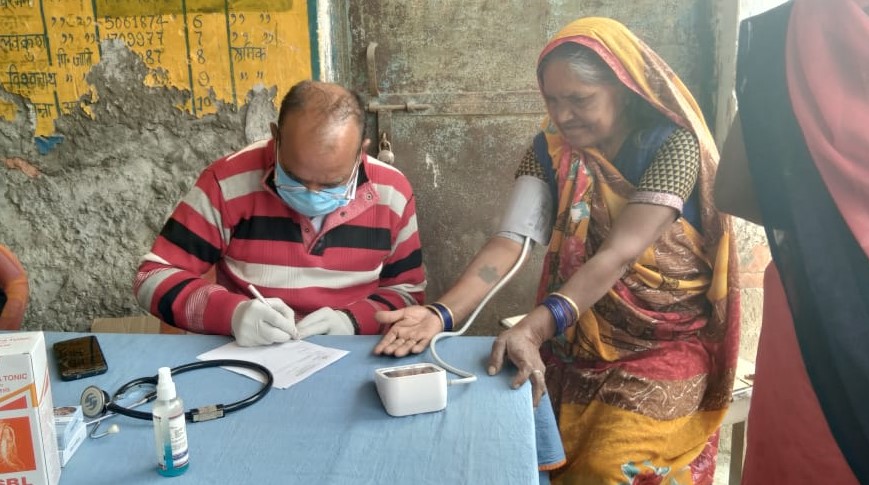 Visiting Doctor screening a woman at a Health Camp in Harahua block of Varanasi