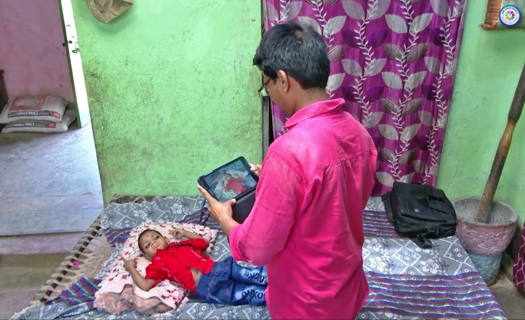 A Community Based Rehabilitation (CBR) worker video capturing physical status of a child with disability